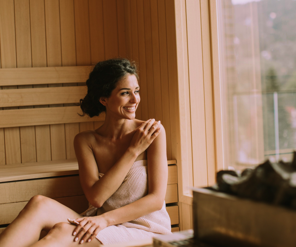 Woman relaxing inside a wood sauna